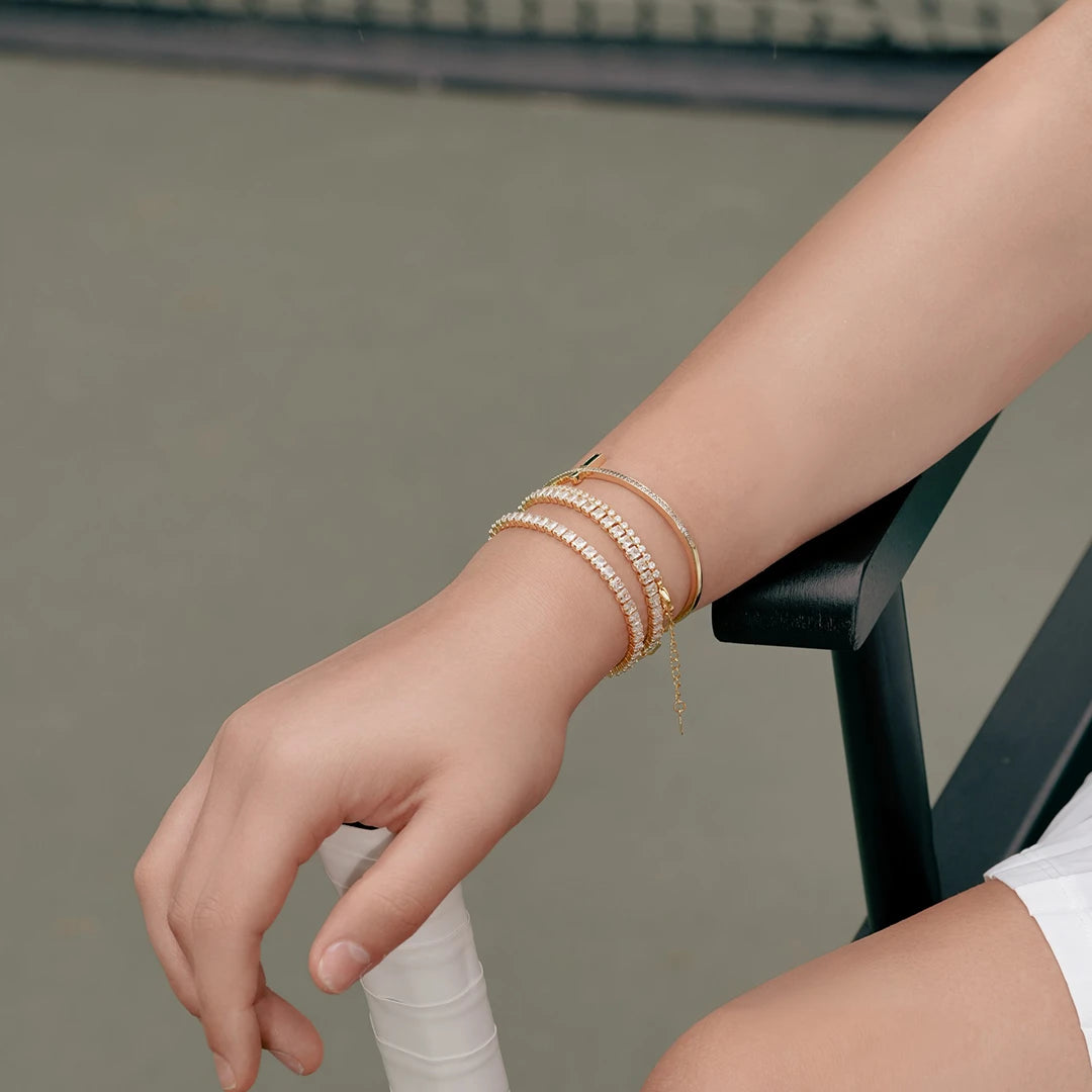 Gold Tennis Bracelet in CZ Accent worn on a model's wrist, close-up