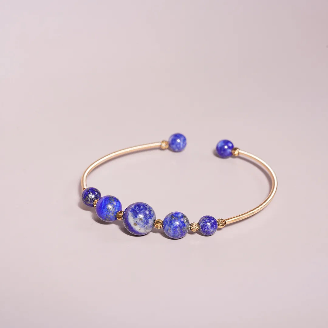 Lapis Lazuli Beaded Gold Open Wire Bracelet styled on a soft-toned background