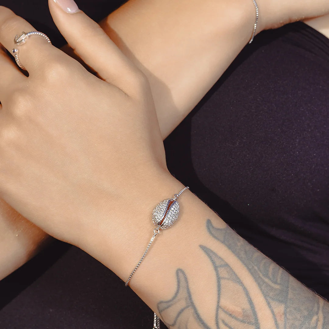 Zard Jewelry Seashell Shaped Charm CZ Link Chain Bolo Bracelet worn on a model's wrist