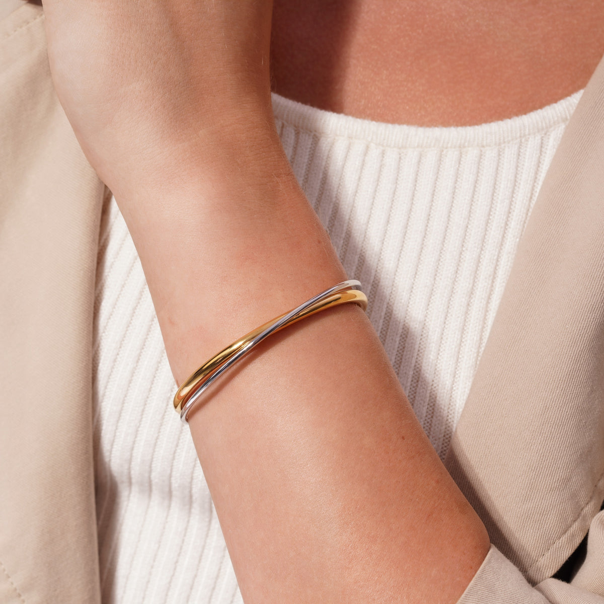 Two Tone Intertwined Cuff Bracelet Gold & Silver worn on a model's wrist