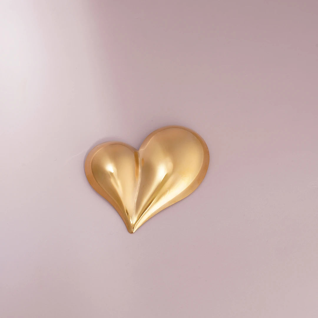 Chunky Puffy Heart Brooch Statement Pin, gold styled on a soft-toned background