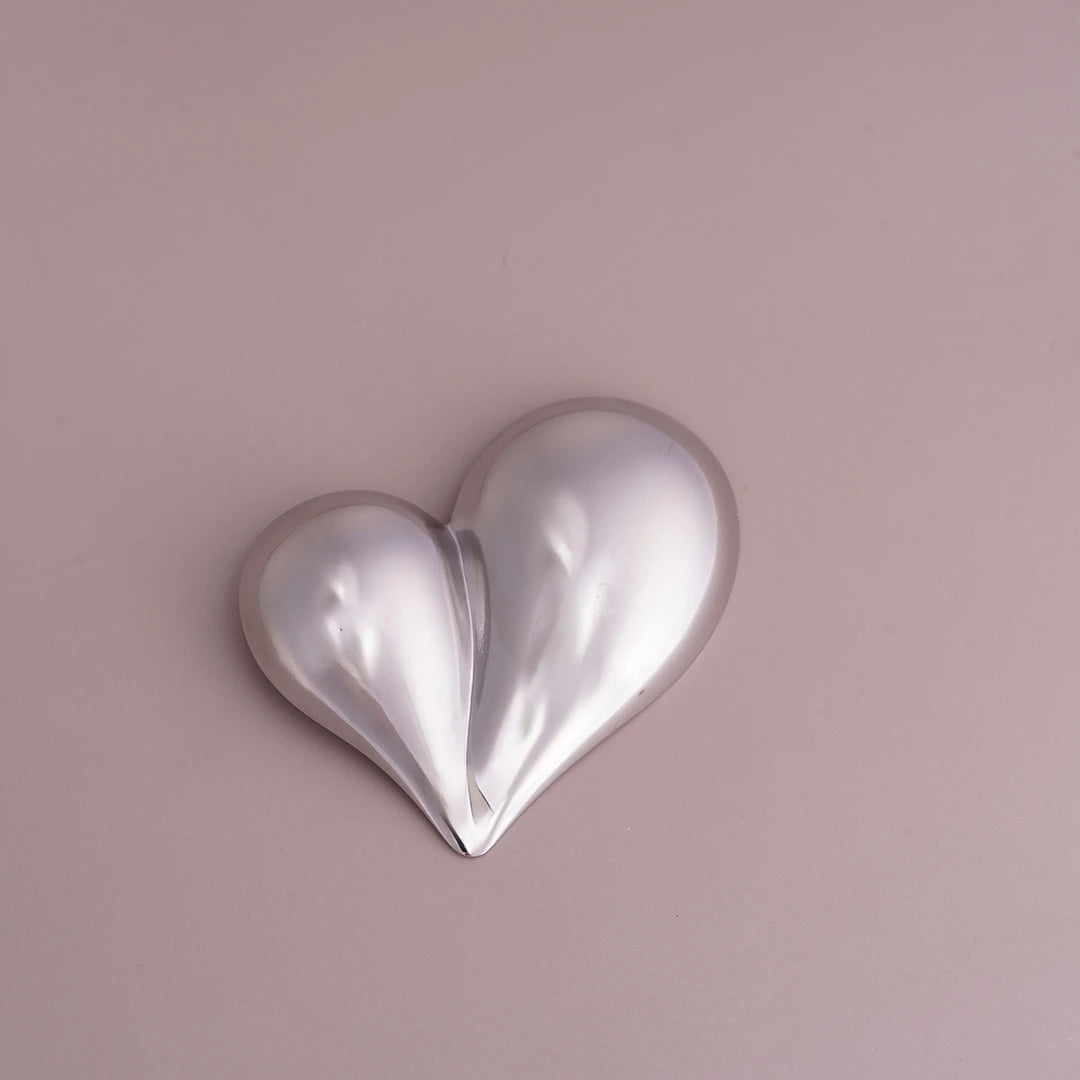 Chunky Puffy Heart Brooch Statement Pin, silver styled on a soft-toned background