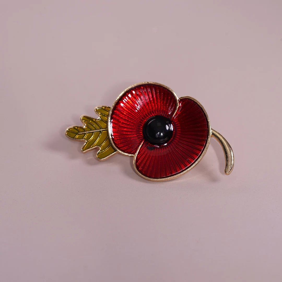 Red Enamel Poppy Flower Brooch Pin styled on a soft-toned background
