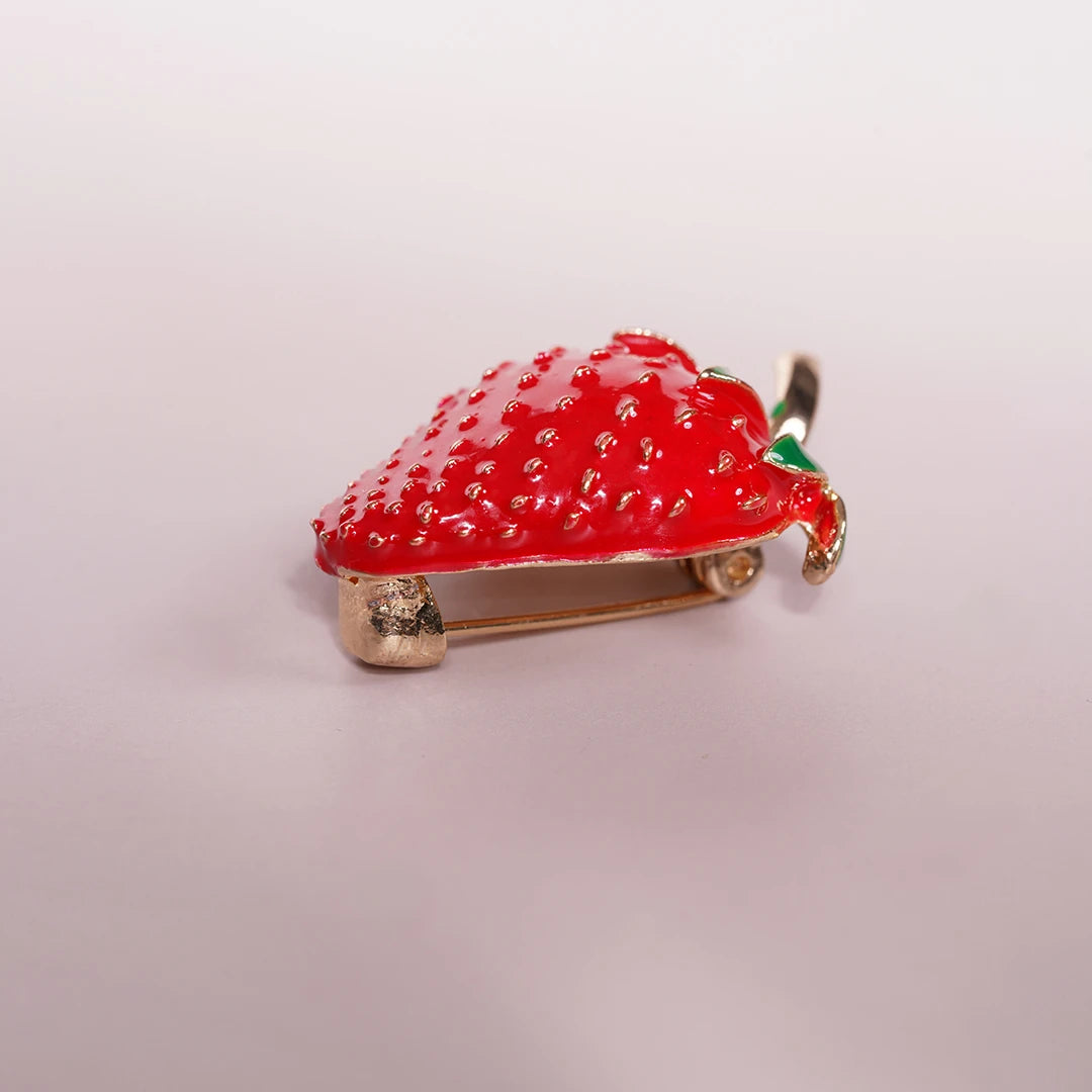 Strawberry Enamel Brooch Pin styled on a soft-toned background, alternate angle