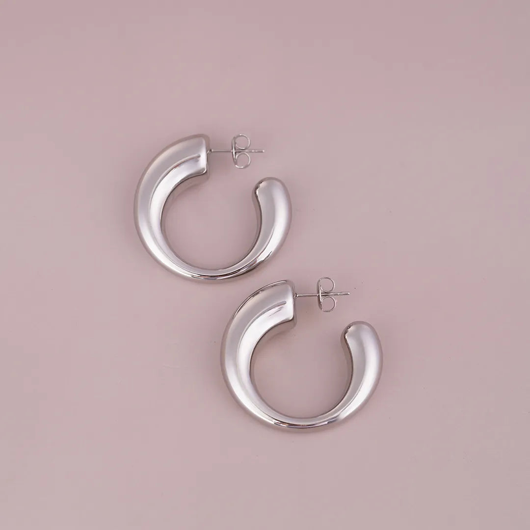 Chunky Irregular Tube Hoop Earrings Sterling Silver styled on a soft-toned background