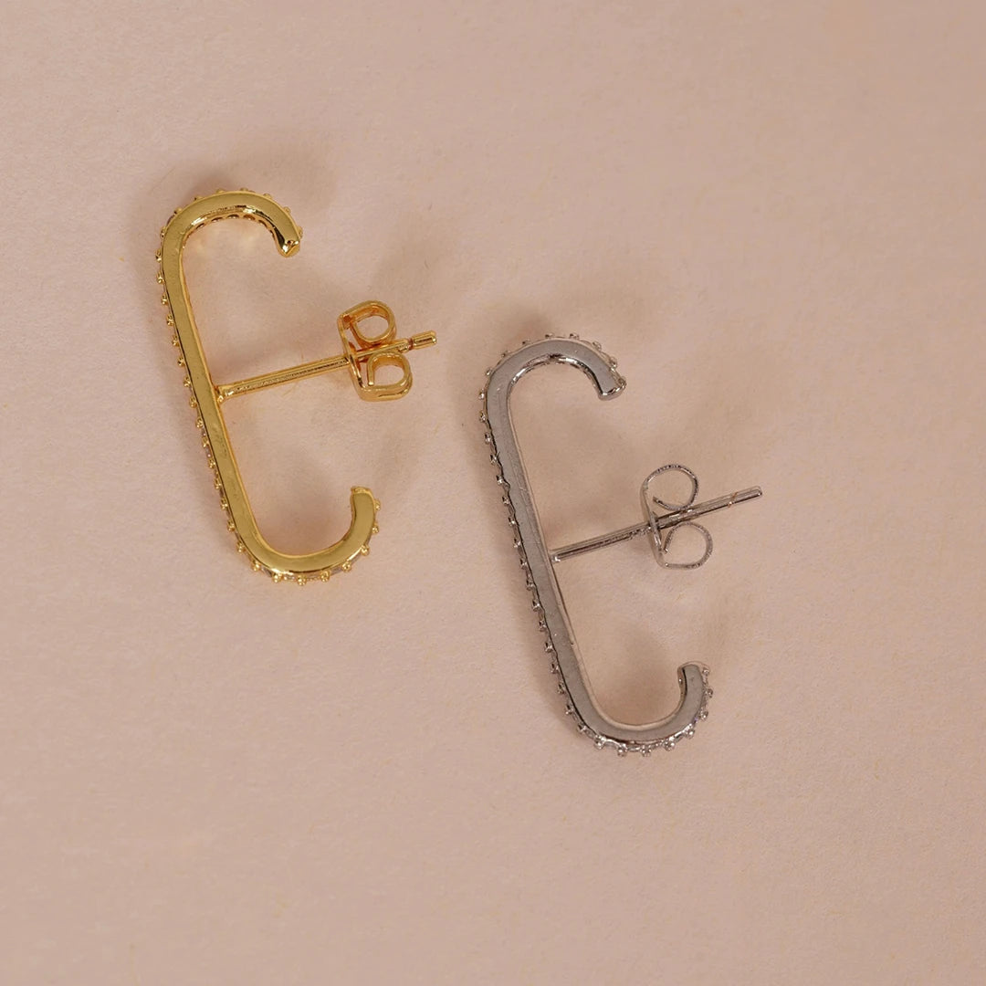CZ Lobe Cuff Studs Suspender Earrings Gold and Silver styled on a soft-toned background