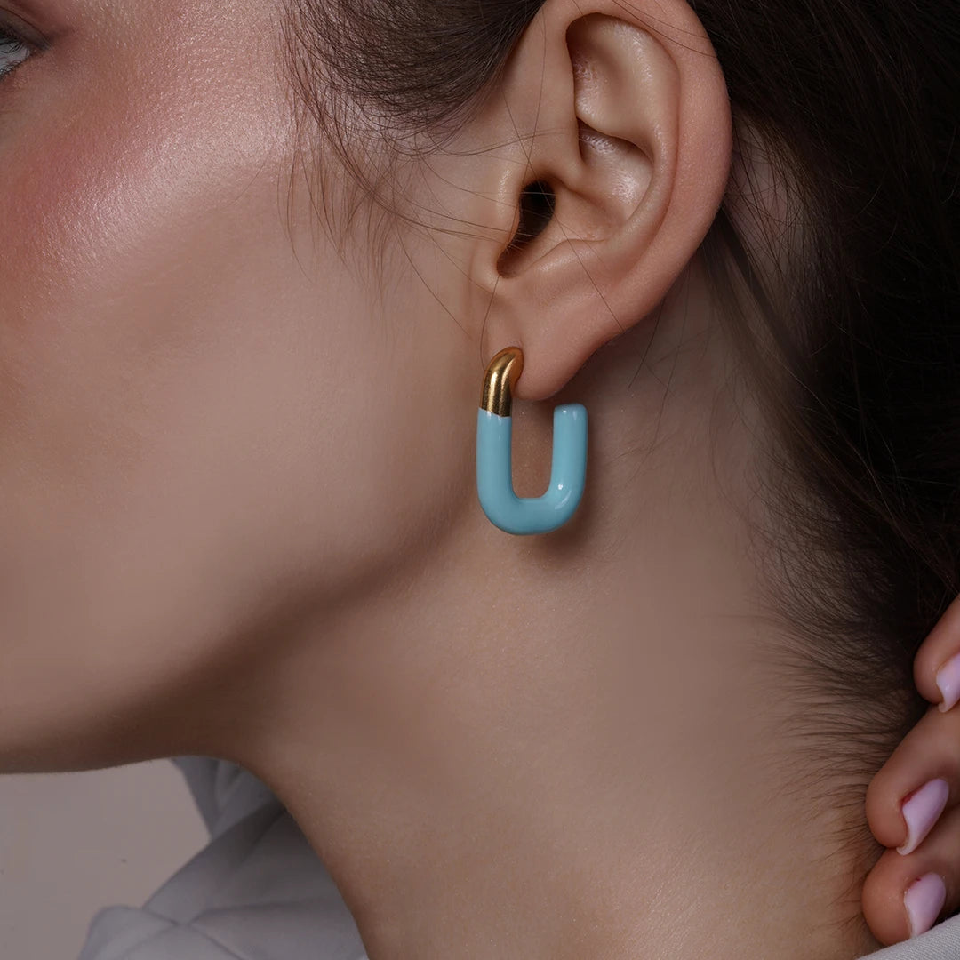 Model wearing Large Enamel Oval Hoop Earrings, alternate pose