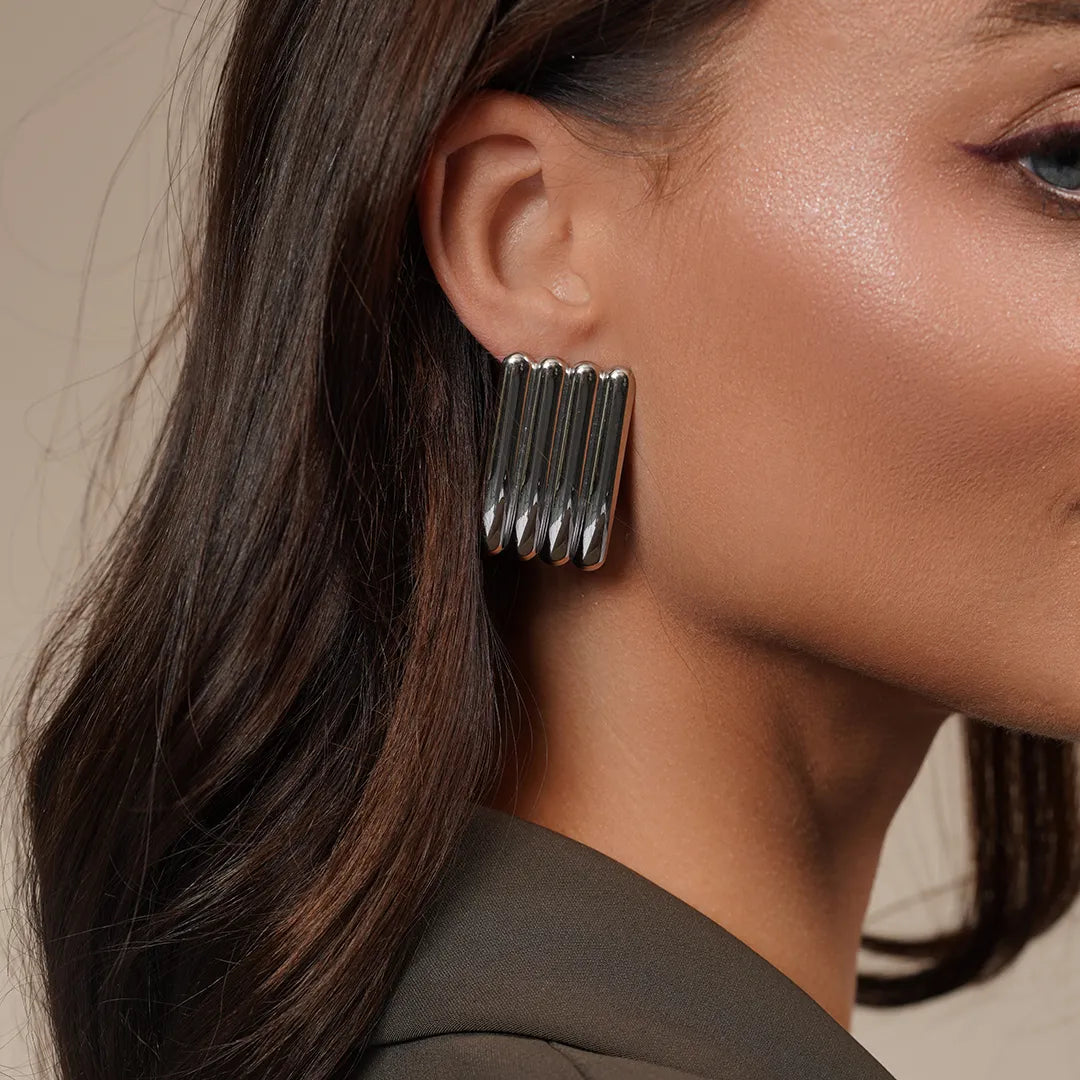 Model wearing Linear Sculpted Earrings in Gold and Silver, alternate pose