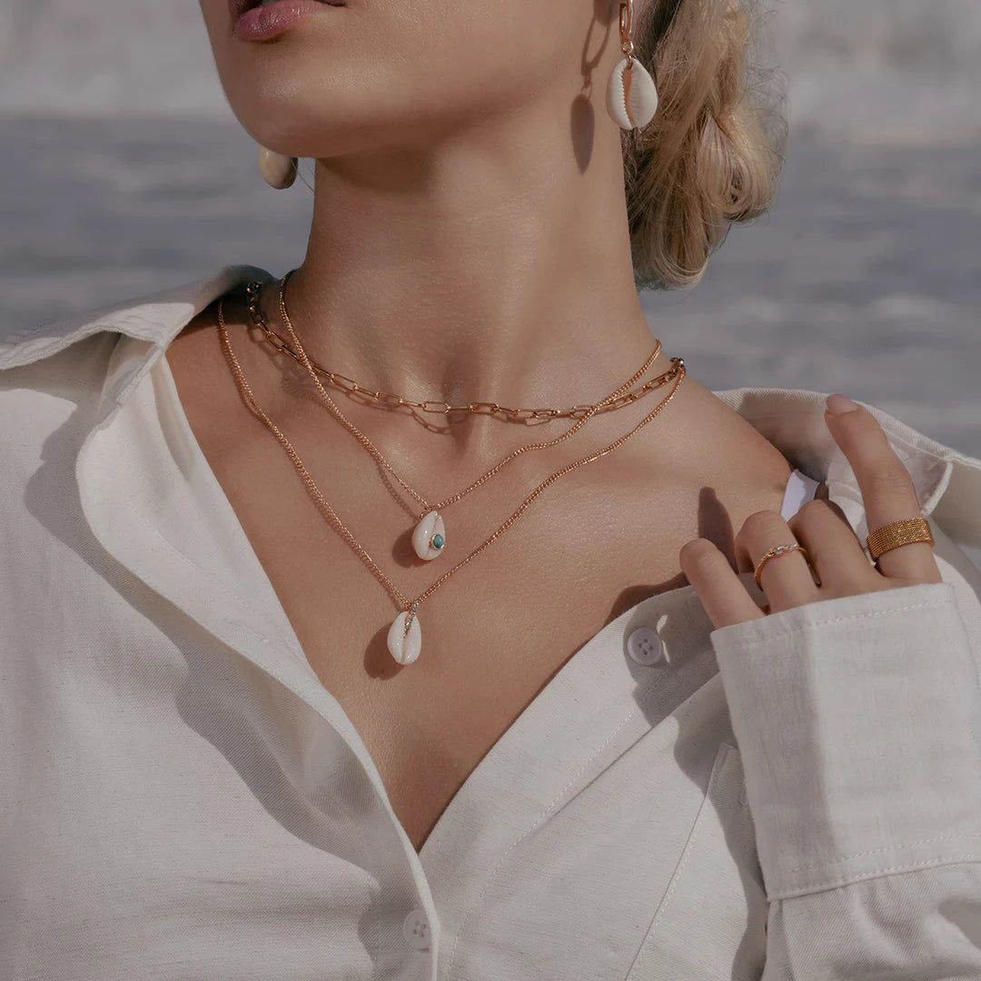 Model wearing Natural Shell Charm Double Layered Necklace around her neck, alternate pose