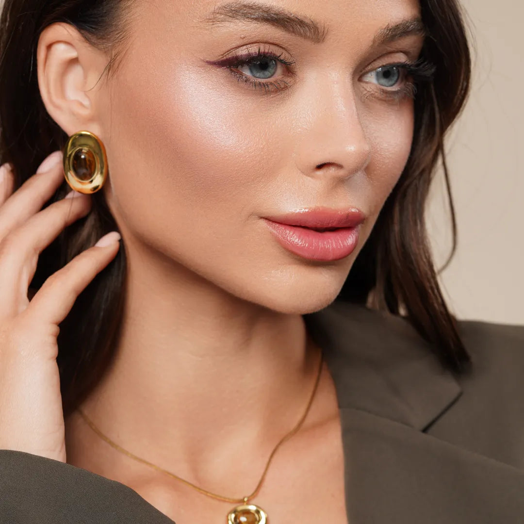 Model wearing Tiger Eye Oval Pendant Necklace around her neck, close-up