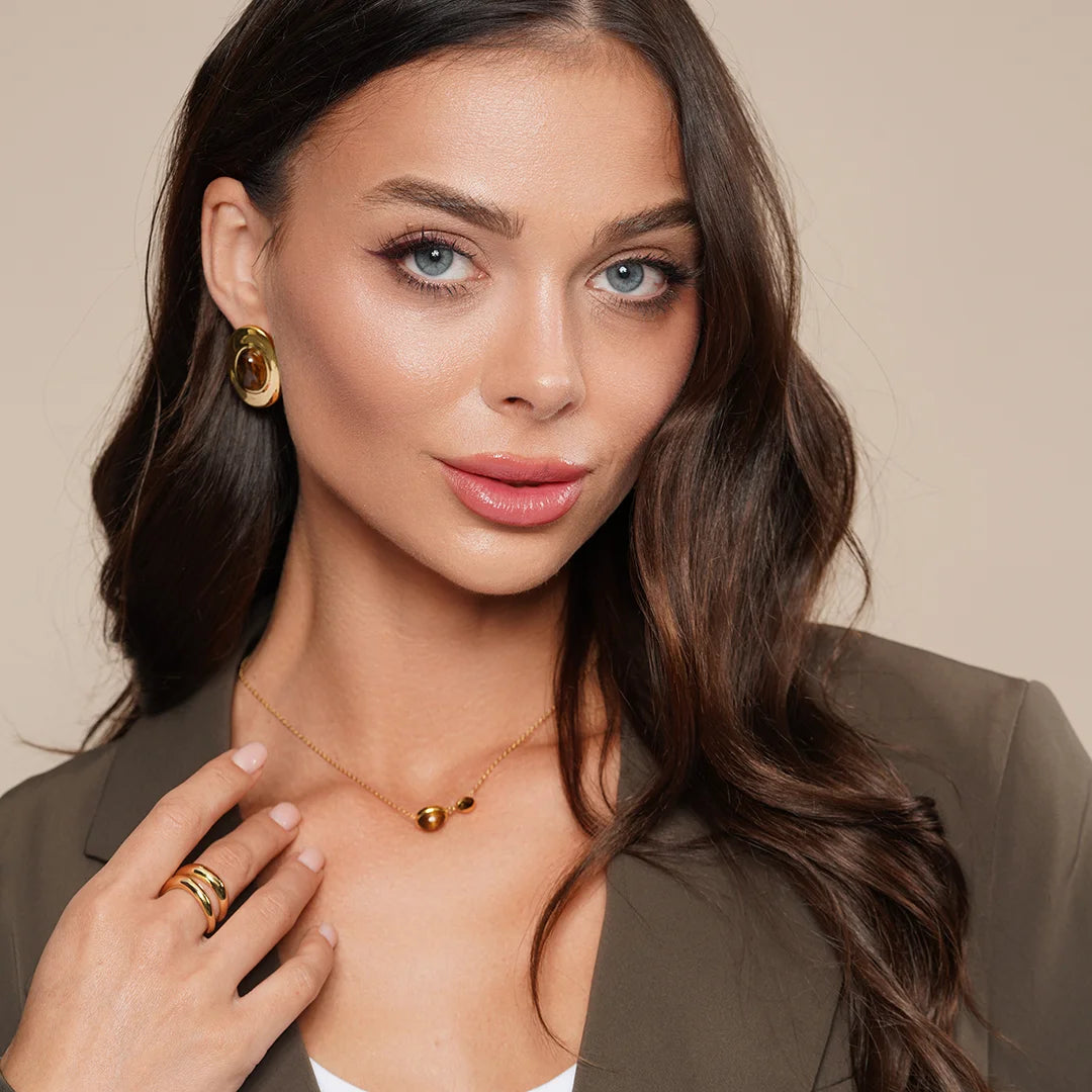 Model wearing Tiger Eye Pendant Necklace in 18K Gold around her neck, alternate pose
