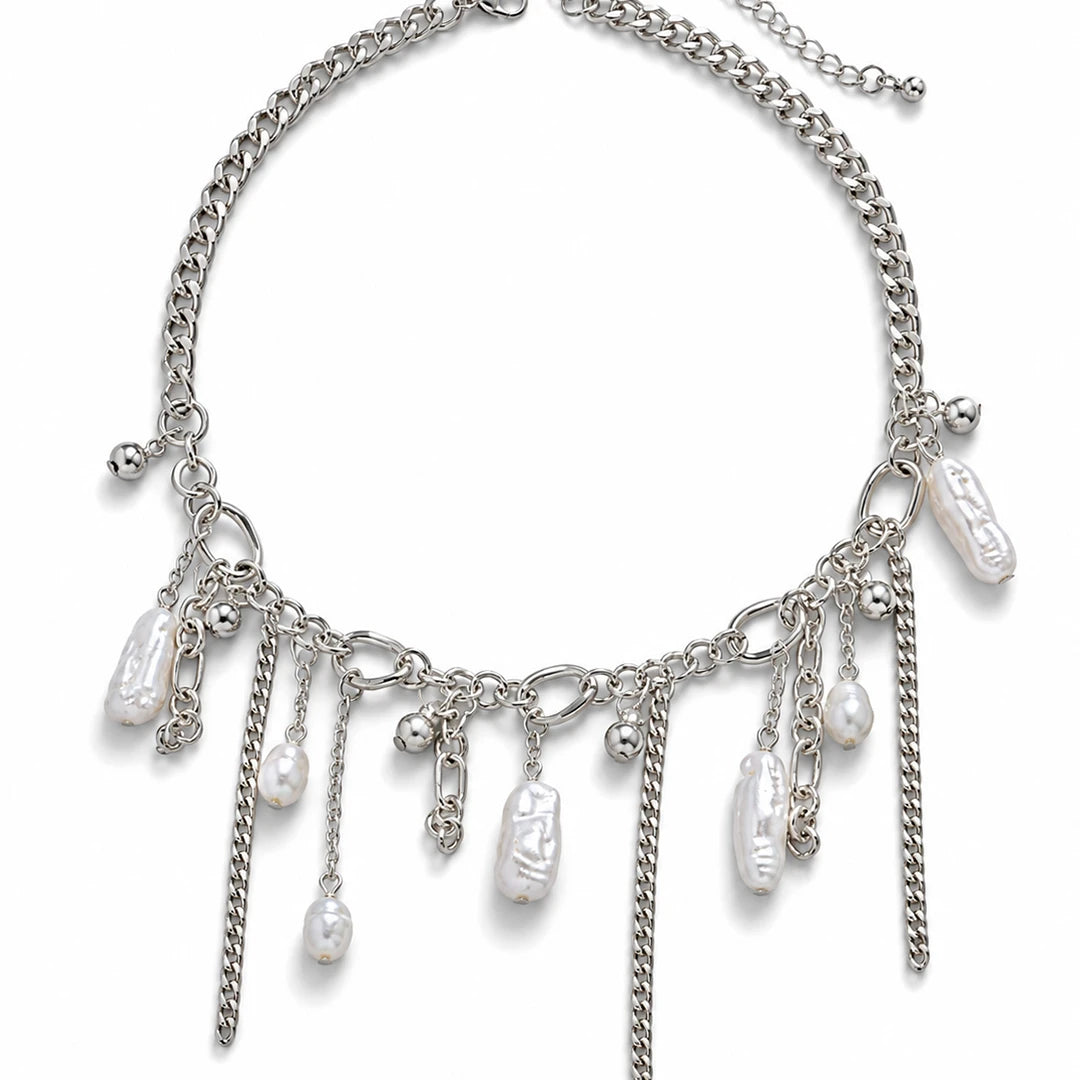 A silver-tone chain necklace with multiple dangling charms, including textured white baroque pearls, small silver beads, and chain drops, shown on a plain white background.