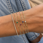 Blue CZ Figaro Chain Bracelet worn on a model's wrist