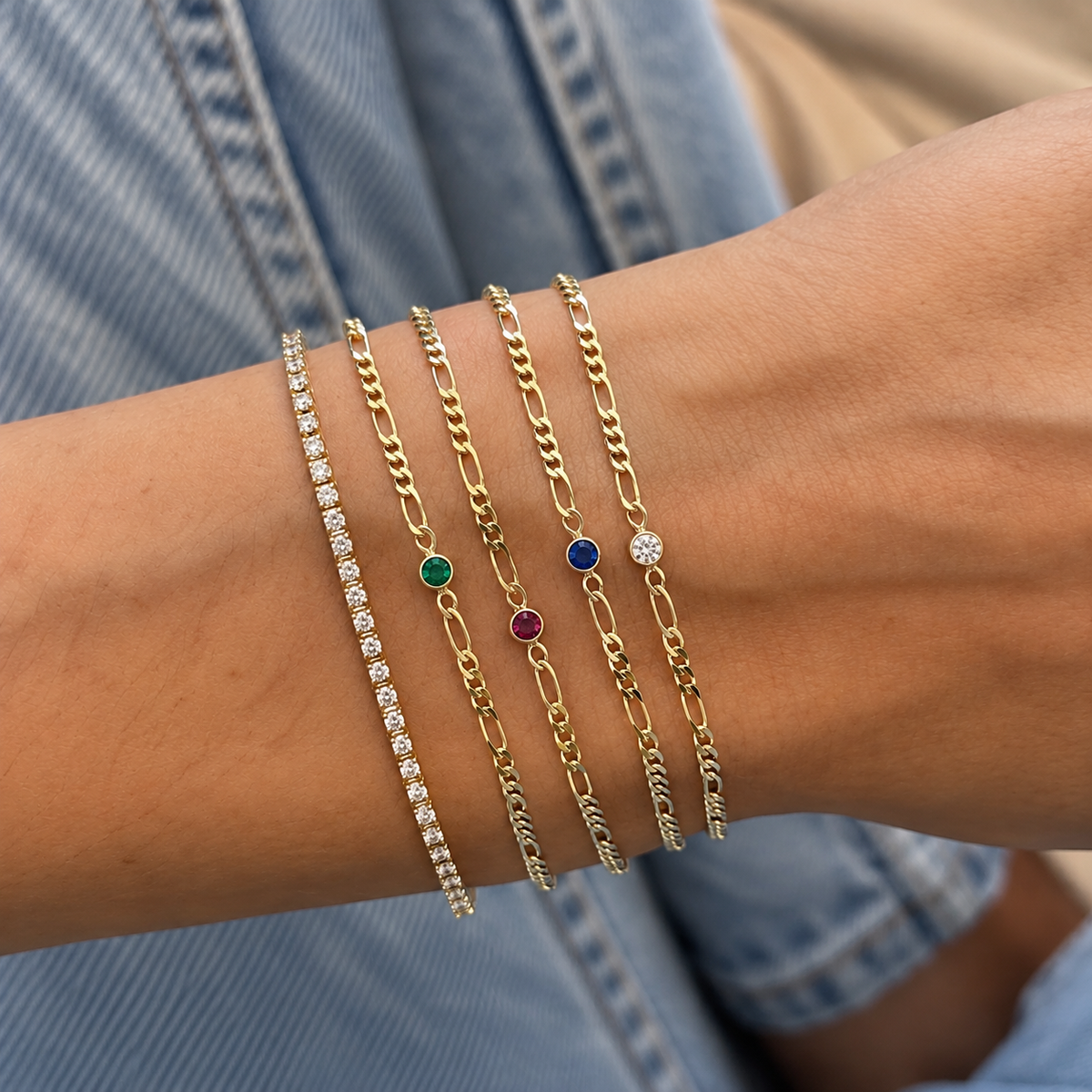 Green CZ Figaro Chain Bracelet worn on a model's wrist