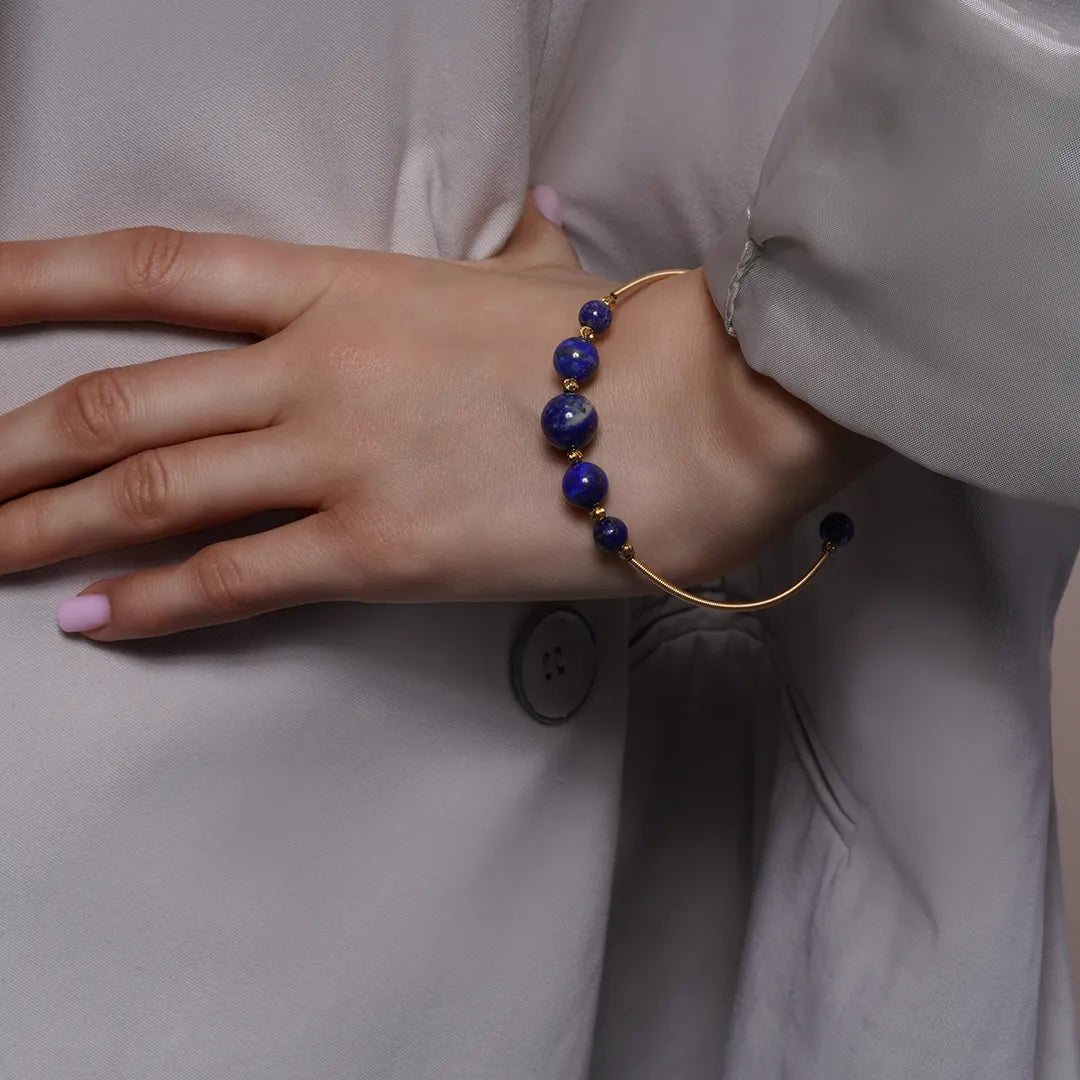 Lapis Lazuli Beaded Gold Open Wire Bracelet worn on a model's wrist, alternate pose
