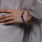 Lapis Lazuli Beaded Gold Open Wire Bracelet worn on a model's wrist, alternate pose