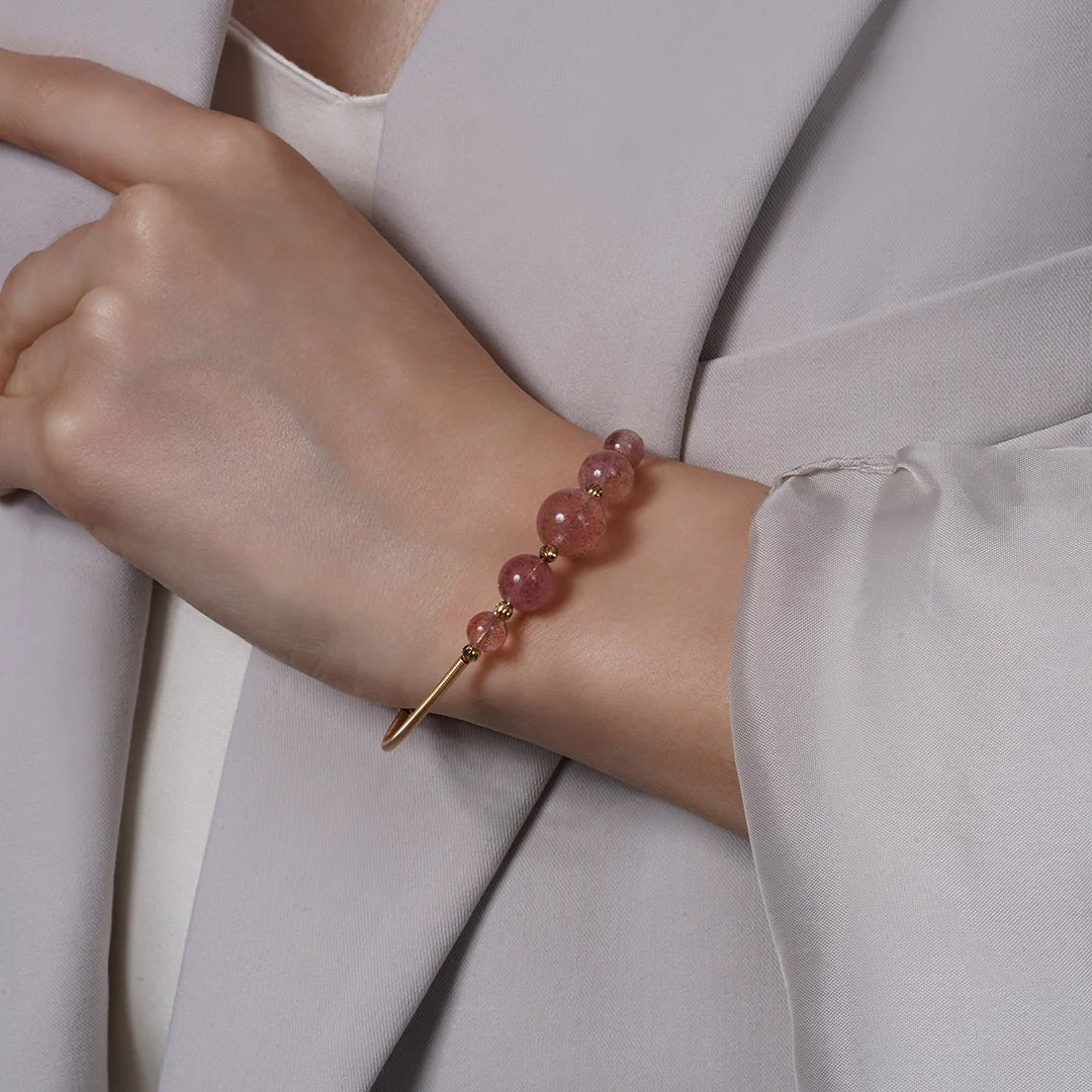 Rose Quartz Beaded Gold Open Wire Bracelet worn on a model's wrist, alternate pose