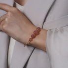 Rose Quartz Beaded Gold Open Wire Bracelet worn on a model's wrist, alternate pose