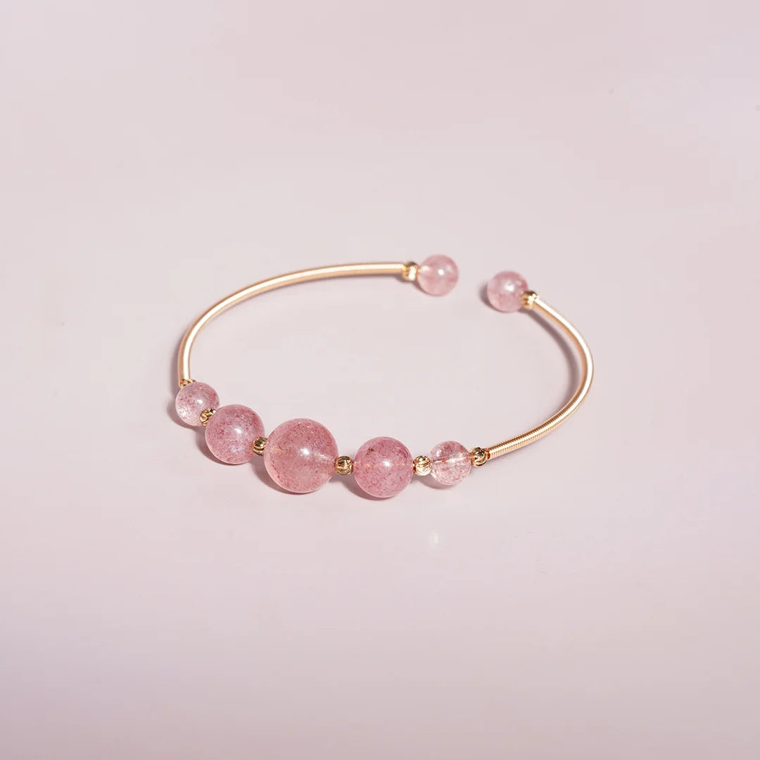 Rose Quartz Beaded Gold Open Wire Bracelet styled on a soft-toned background