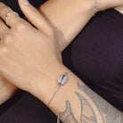 Zard Jewelry Seashell Shaped Charm CZ Link Chain Bolo Bracelet worn on a model's wrist