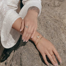 Seashell Shaped Charm CZ Link Chain Bolo Bracelet worn on a model's wrist, alternate pose