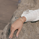 Seashell Shaped Charm CZ Link Chain Bolo Bracelet worn on a model's wrist, close-up
