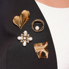 Model wearing Zard Jewelry brooches, close-up