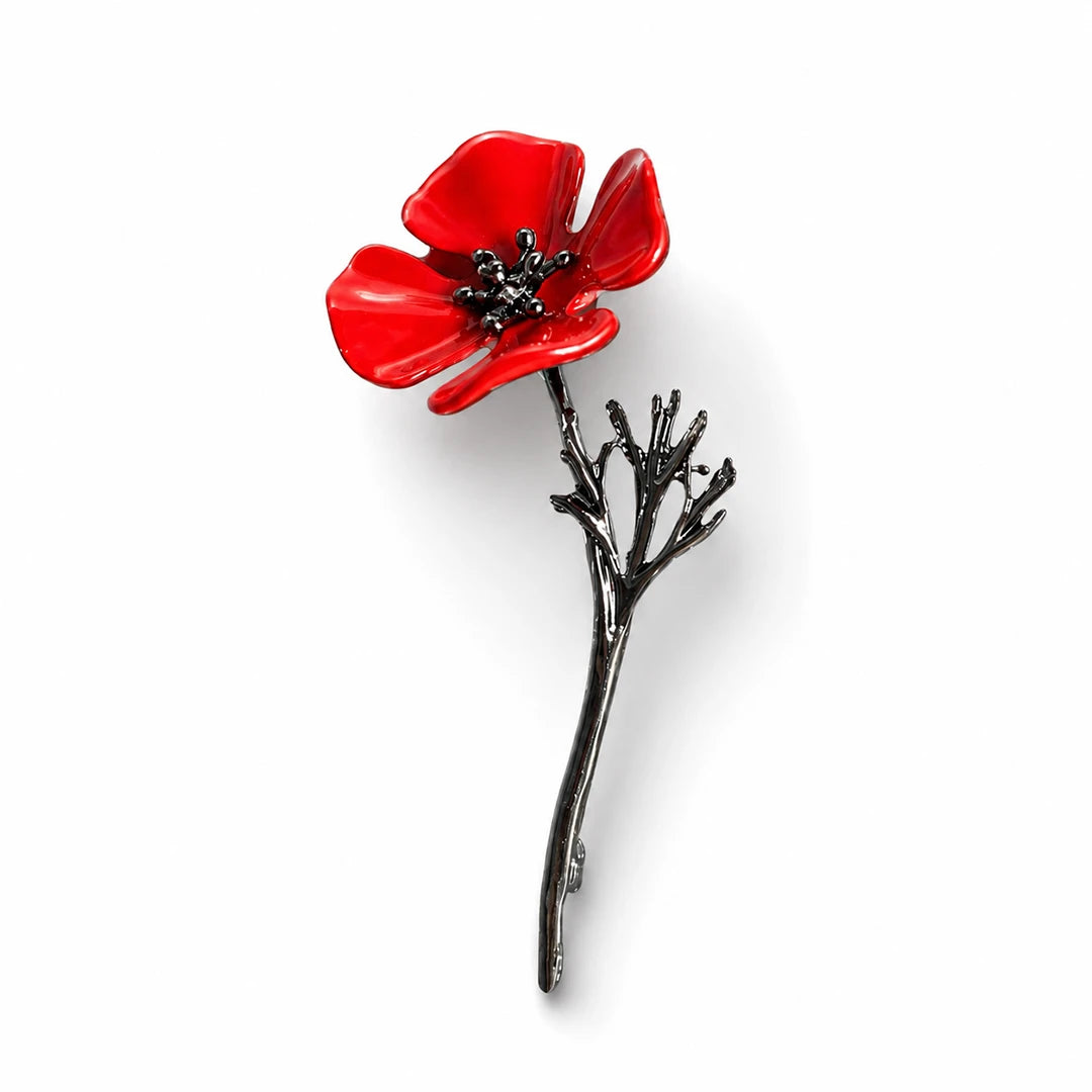 Red enamel poppy brooch with a dark metallic stem and branching leaves, front view.