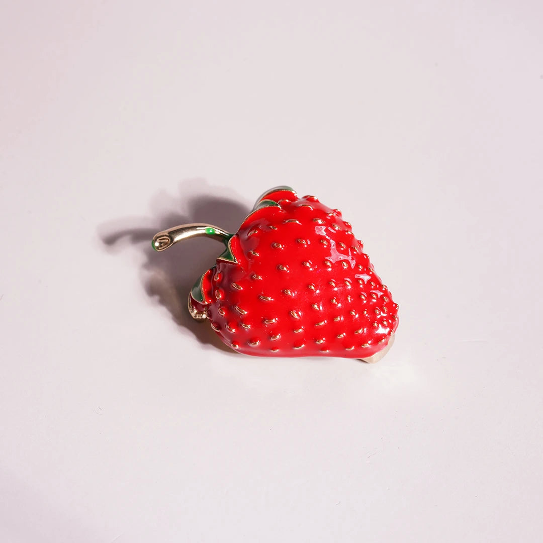 Strawberry Enamel Brooch Pin styled on a soft-toned background