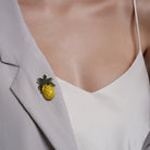 Yellow Enamel Pineapple Brooch pinned to a model's outfit