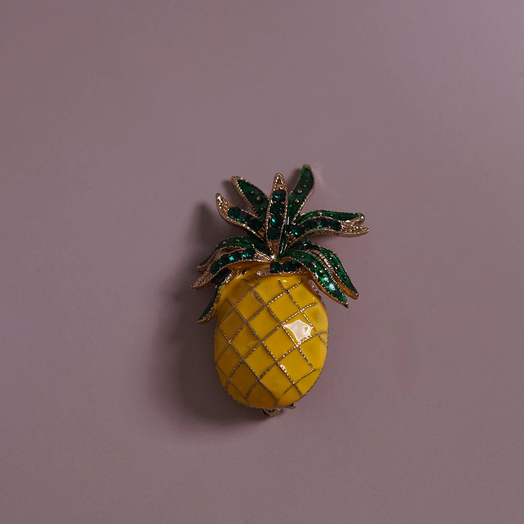 Yellow Enamel Pineapple Brooch styled on a soft-toned background