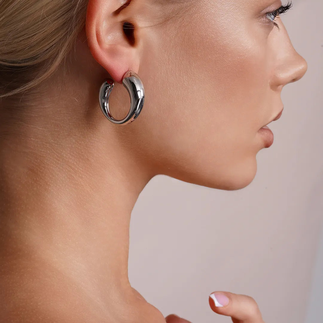 Model wearing Zard Jewelry Chunky Irregular Tube Hoop Earrings Sterling Silver