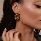 Model wearing Chunky Oval Stud Earrings in Enamel Accent