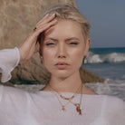 Model wearing Zard Jewelry Cowrie Shell Hoop Earrings in CZ Accent