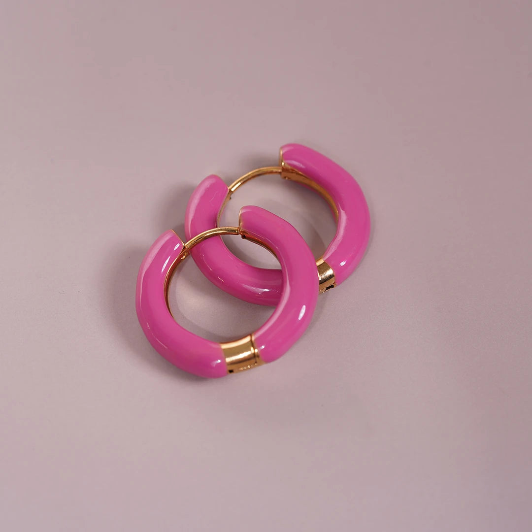 Enamel Hoop Earrings, pink styled on a soft-toned background
