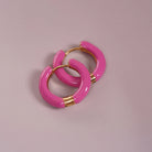 Enamel Hoop Earrings, pink styled on a soft-toned background