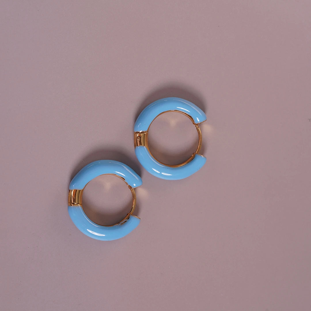 Enamel Hoop Earrings, blue styled on a soft-toned background