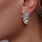 Model wearing Flower Petals Cubic Zirconia and Pearl Earrings, alternate pose