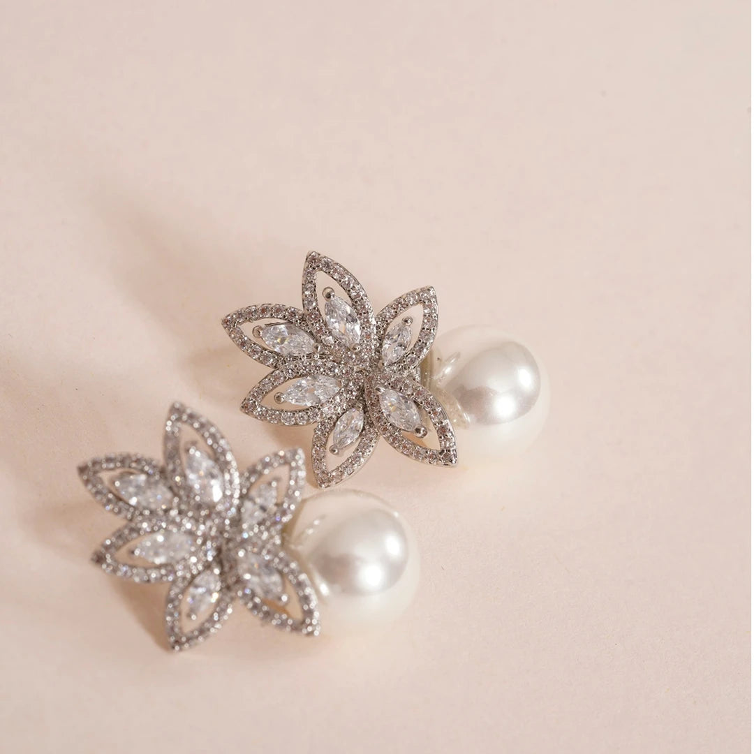 Flower Petals Cubic Zirconia and Pearl Earrings styled on a soft-toned background