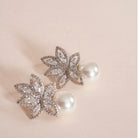 Flower Petals Cubic Zirconia and Pearl Earrings styled on a soft-toned background