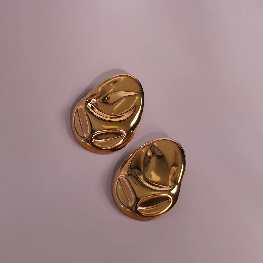 Hammered Statement Chunky Earrings In Gold and Silver styled on a soft-toned background