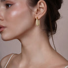 Model wearing Large Enamel Oval Hoop Earrings