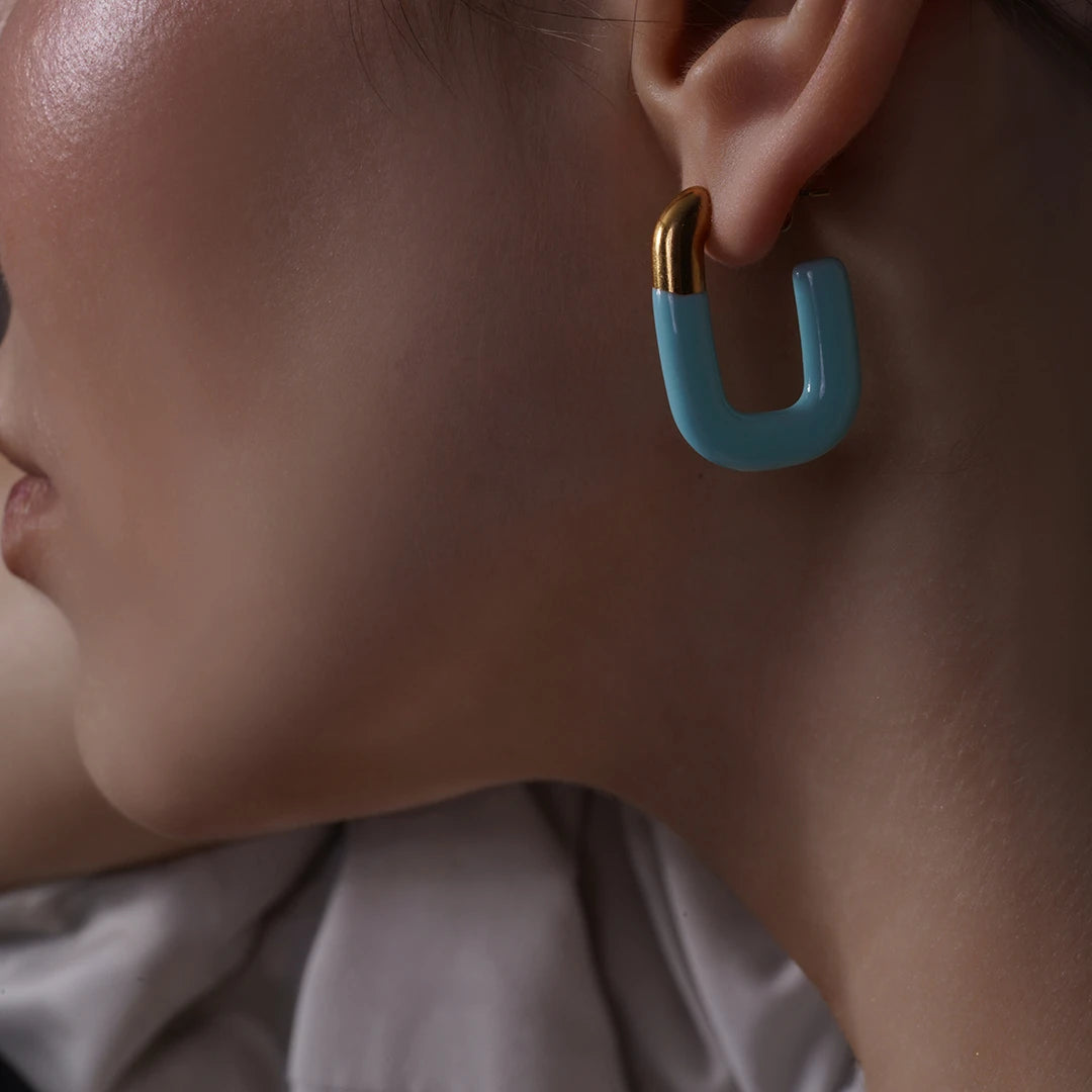 Model wearing Large Enamel Oval Hoop Earrings, close-up