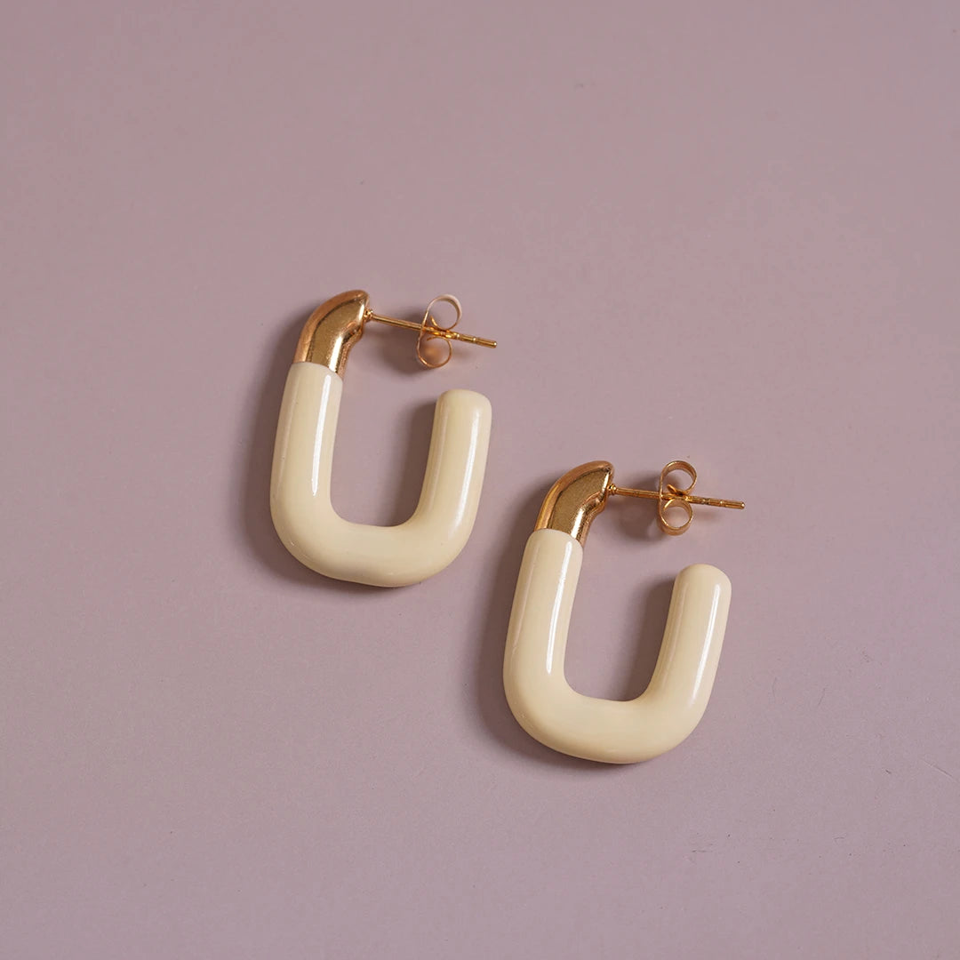 Large Enamel Oval Hoop Earrings, yellow styled on a soft-toned background