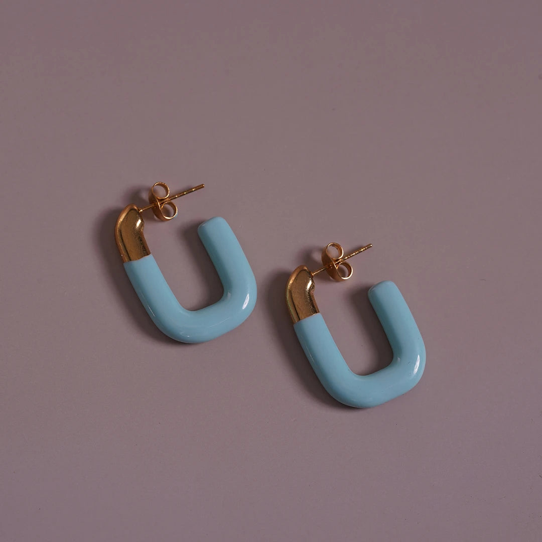 Large Enamel Oval Hoop Earrings, blue styled on a soft-toned background