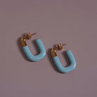 Large Enamel Oval Hoop Earrings, blue styled on a soft-toned background