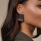 Model wearing Linear Sculpted Earrings in Gold and Silver, alternate pose