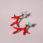 Red Coral Enamel Drop Earrings in Pearl and Turquoise Stone Accent styled on a soft-toned background