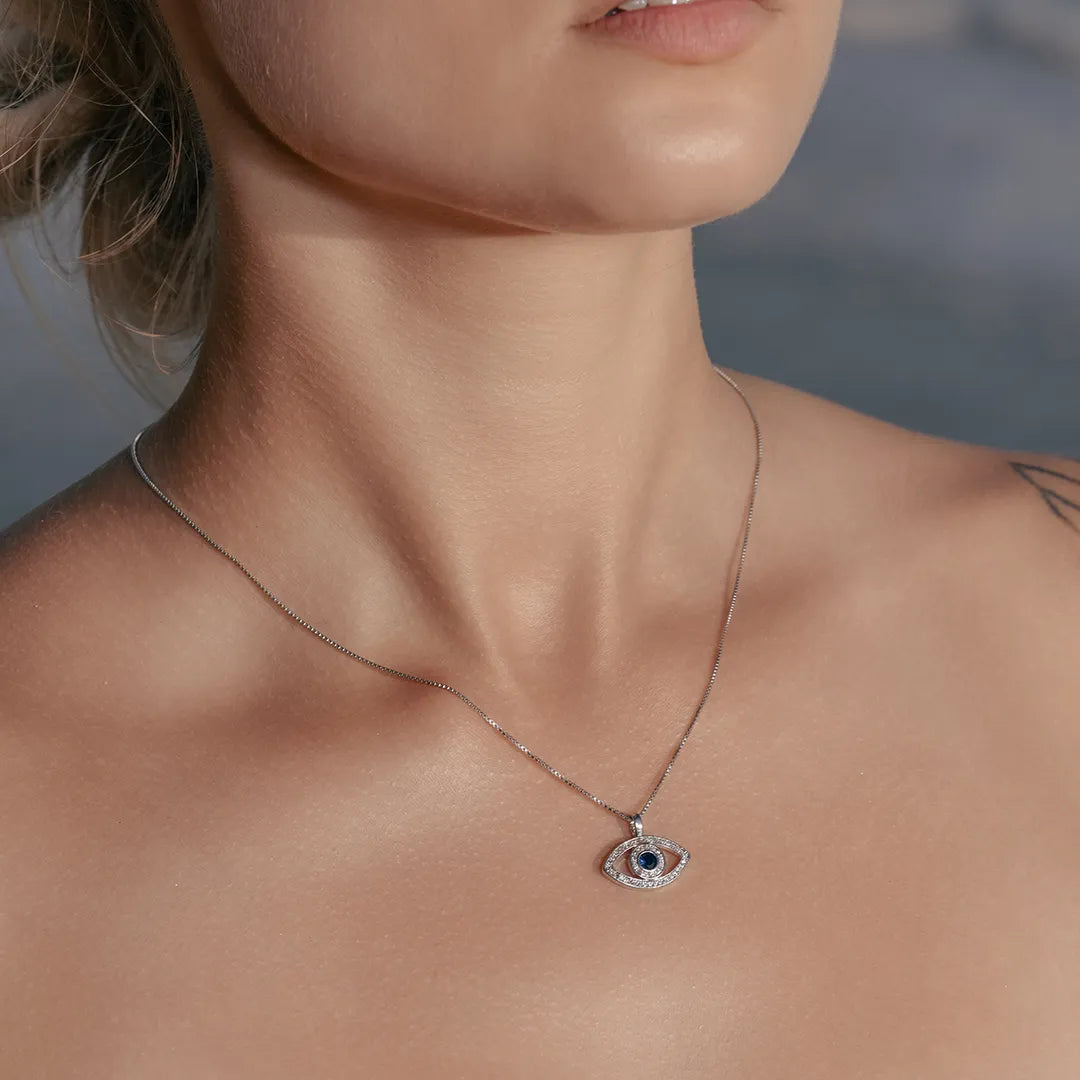 Model wearing Zard Jewelry Blue Evil Eye Pendant Necklace in Sterling Silver around her neck