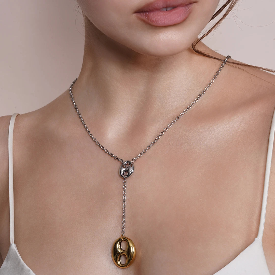 Model wearing Lariat Necklace in Puffed Mariner Silver Gold Charm around her neck